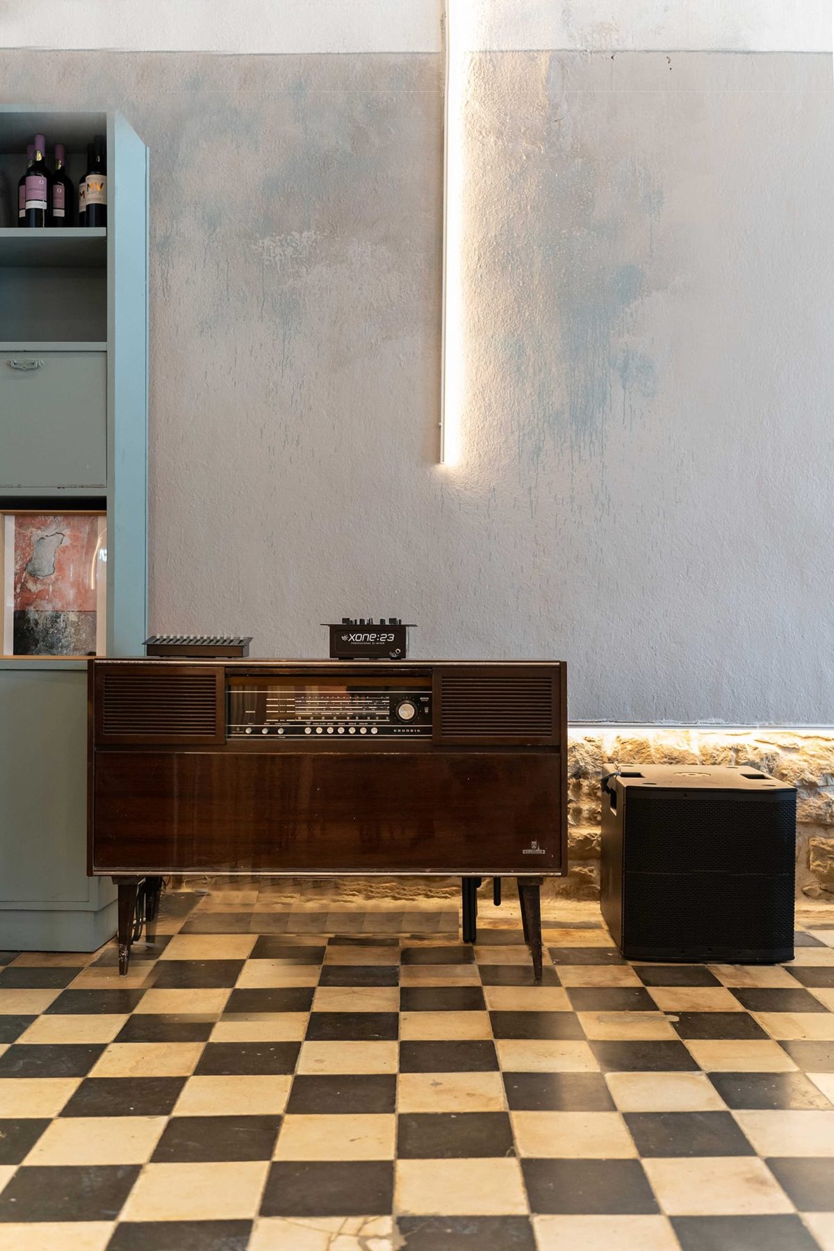 Παλιό ραδιόφωνο Grundig με μίκτη DJ πάνω σε ασπρόμαυρο δάπεδο